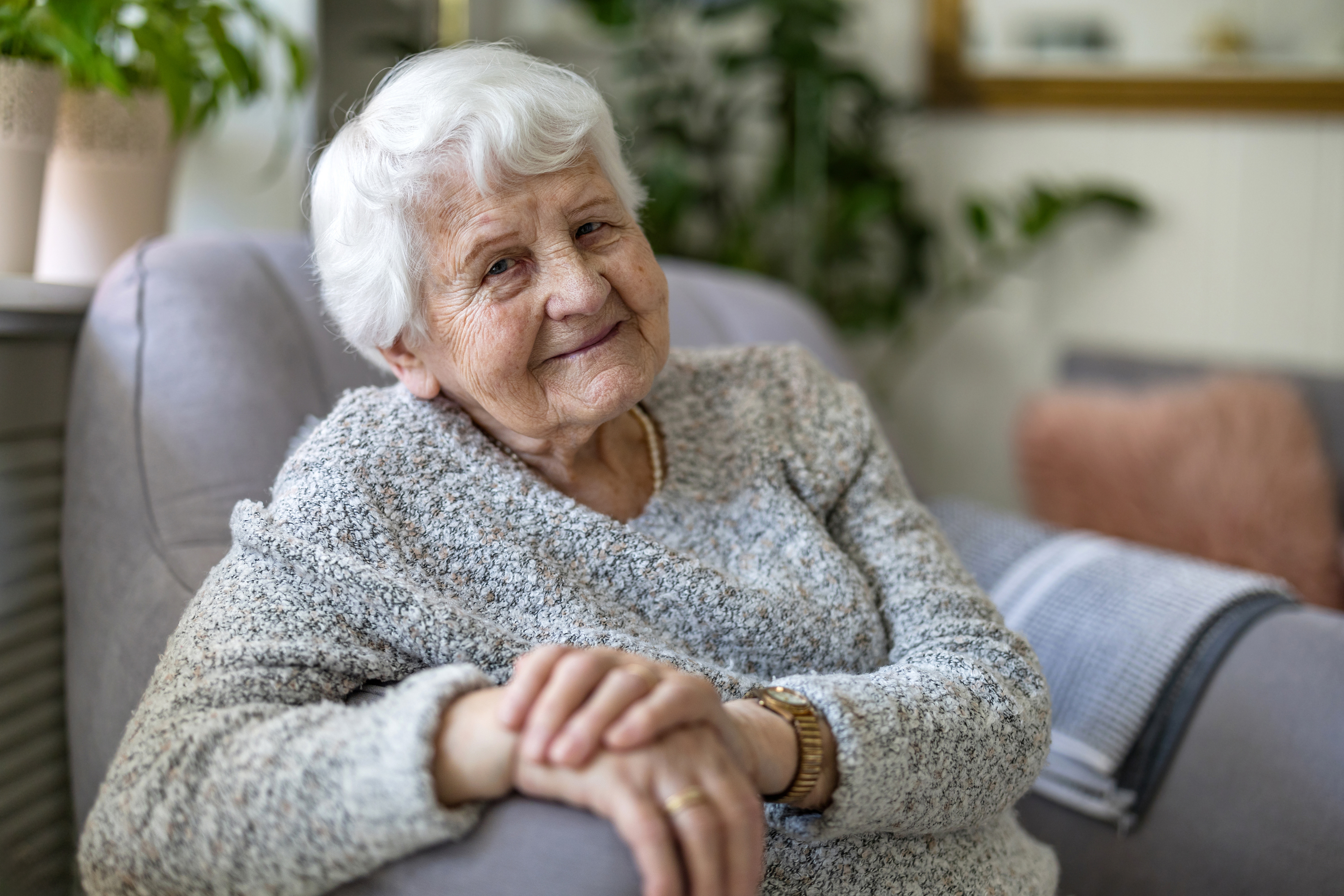 Happy senior at home who just got a home care package